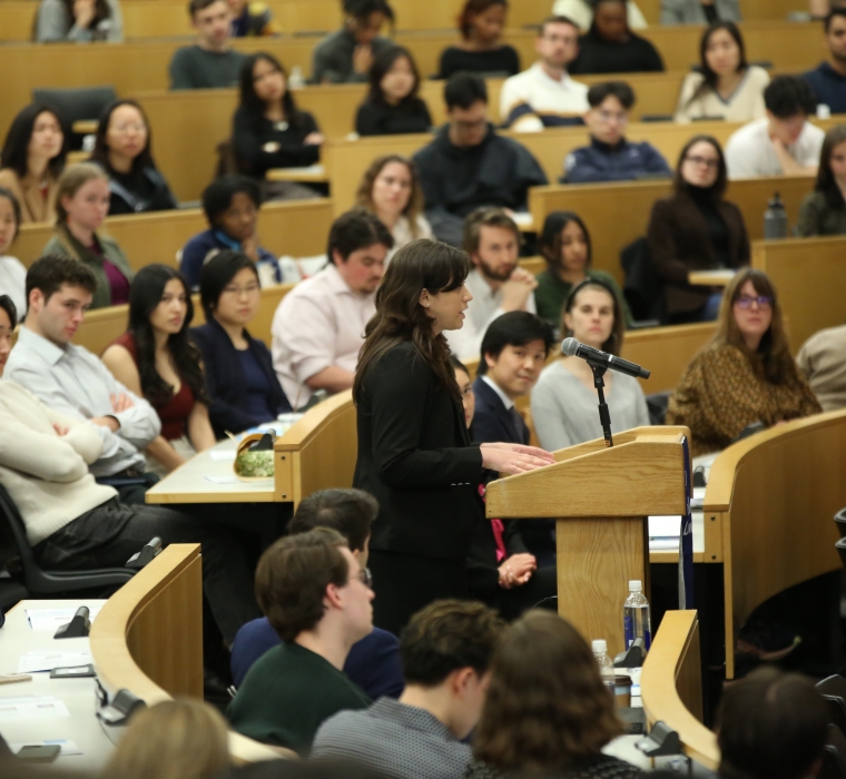 A speaker at a podium in a classroom