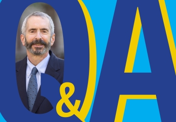 Q&A graphic with photo of bearded man in a suit.