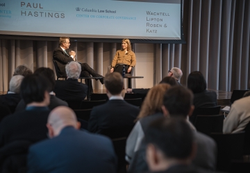 Man and woman onstage in conversation with audience.