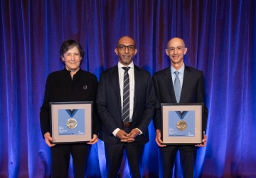 Elizabeth Glazer '86, Dean Daniel Abebe, David Greenwald ’83, with framed medals