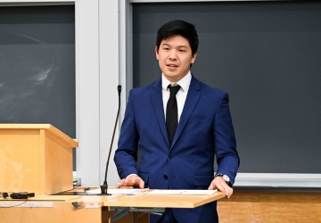 Miles Kim stands behind a podium.