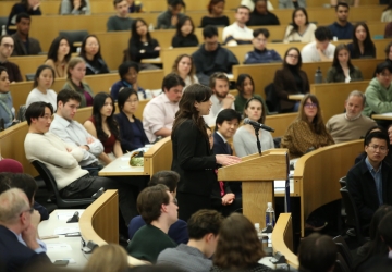 A speaker at a podium in a classroom