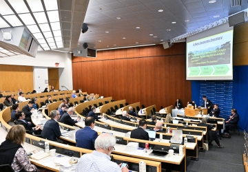 Audience in classroom listening to panel speakers