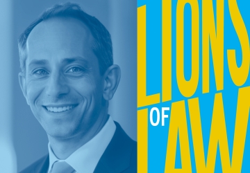 Blue-scale photo of man in suit with "Lions of Law" graphic