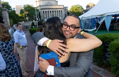 Man and woman hugging with Low Library in background