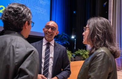 Dean Abebe by podium taling to alumni