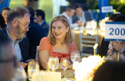 Bearded man and blonde woman chatting at dinner event