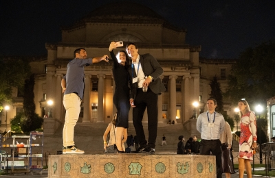 People standing on a sundial shooting a selfie
