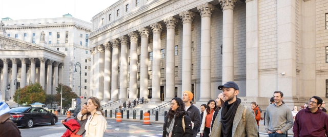 Students from Eric Talley's Contracts class walk in front of a downtown Manhattan courthouse.