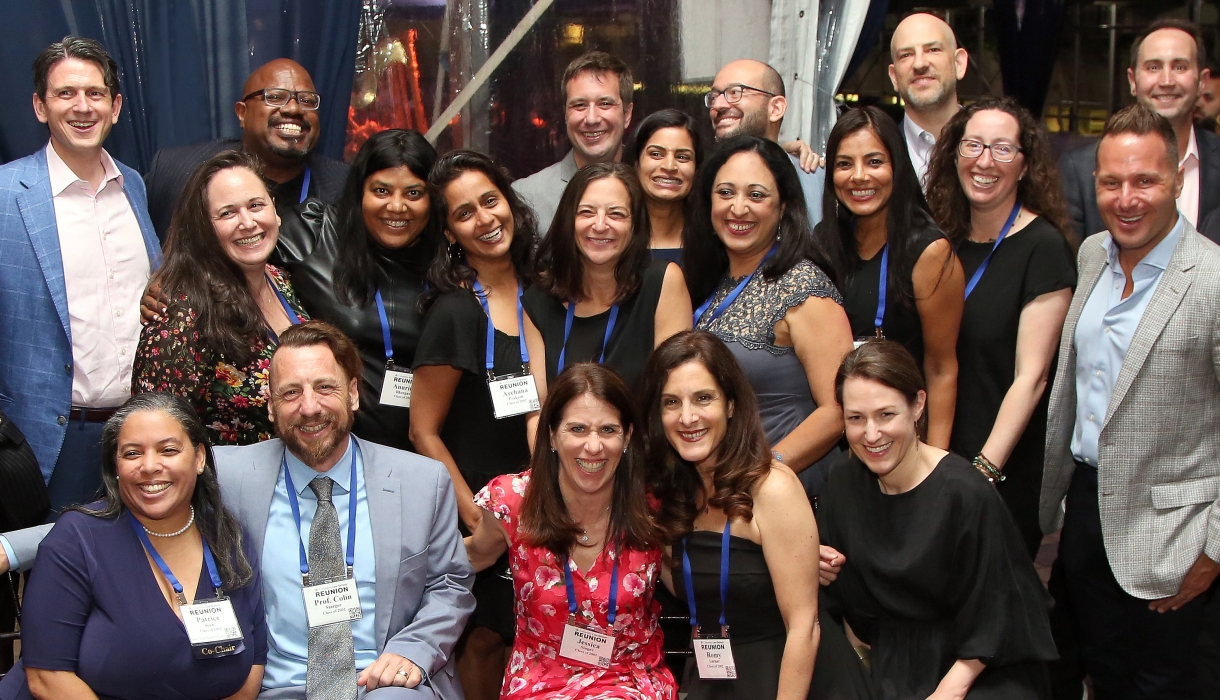 A group of about 20 people posing together