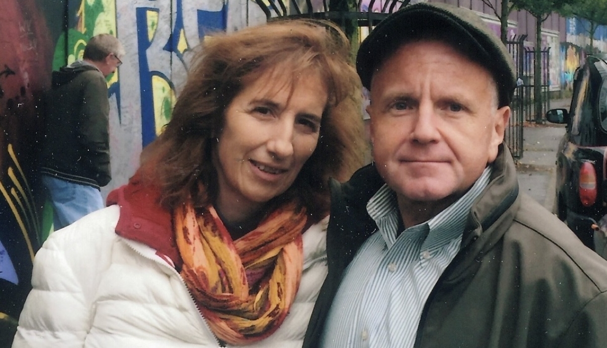 Woman in colorful scarf with man in cap