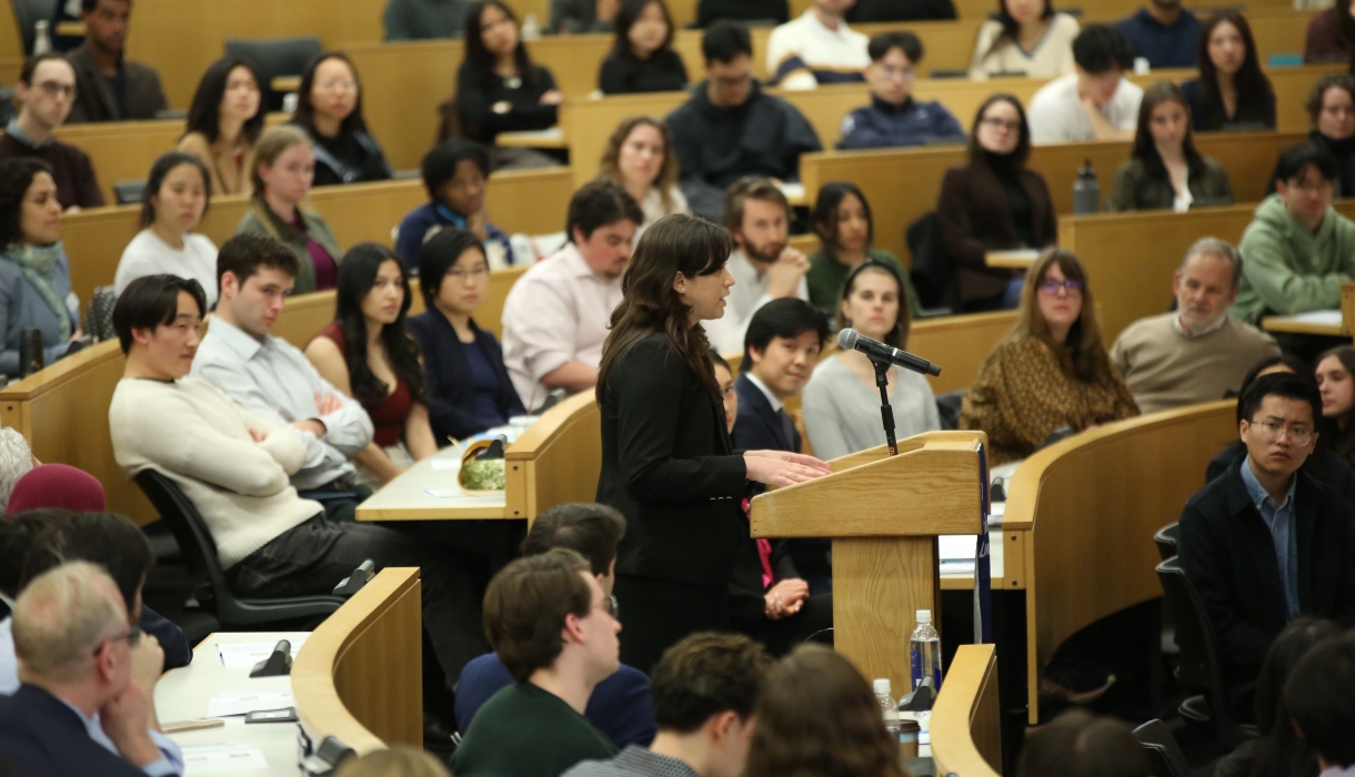 A speaker at a podium in a classroom