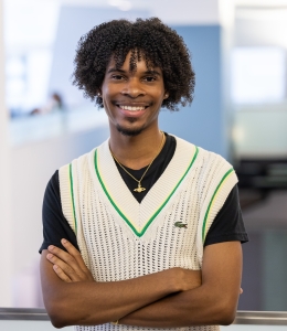 Booker Johnson in white sweater vest over dark T-shirt