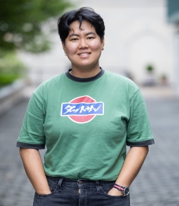 Elliot Lin in green short-sleeve T-shirt with graphic design