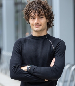 Nua Ljuljdjurovic in dark long-sleeve shirt crossing his arms