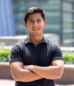 Philip Shen in dark Ralph Lauren polo shirt crossing his arms