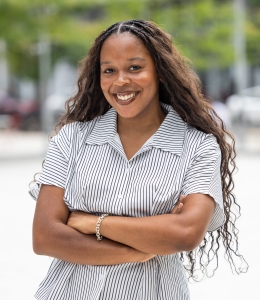 Shelby Williams in striped short-sleeve blouse with arms crossed