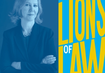 Portrait of a gray haired woman with crossed arms and "Lions of Law" graphic text