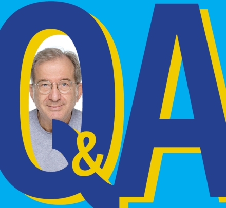 Blue graphic Q&A with photo of gray haired man with glasses.