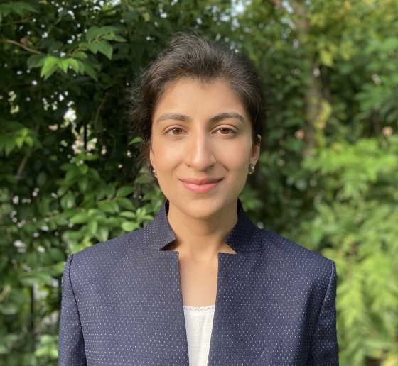 Columbia Law professor Lina Khan in blue jacket and white camisole