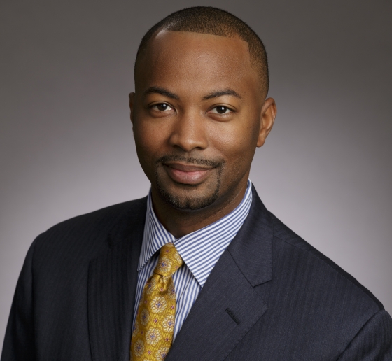 Portrait of man in gray suit with gold tie