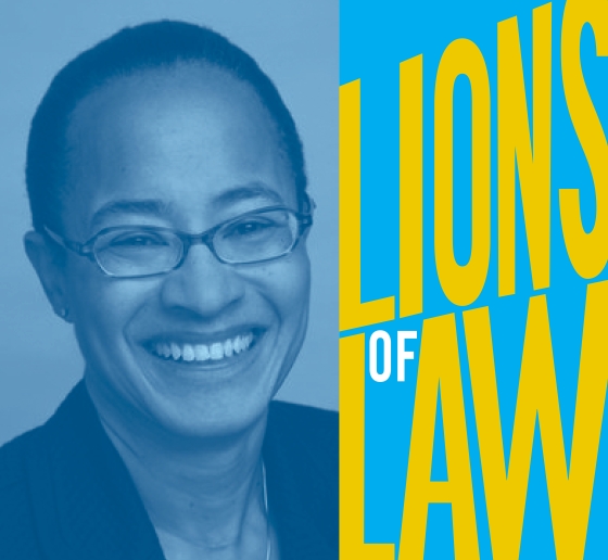 Woman with glasses and cropped haircut with Lions of Law logo