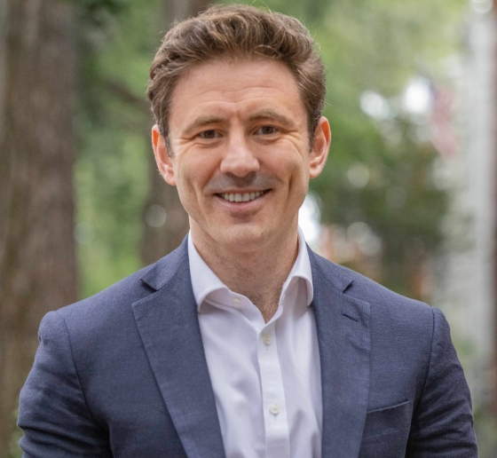 Professor Michael Love wearing a suit jacket and smiling