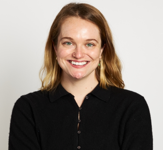 Smiling blonde white woman in black shirt 