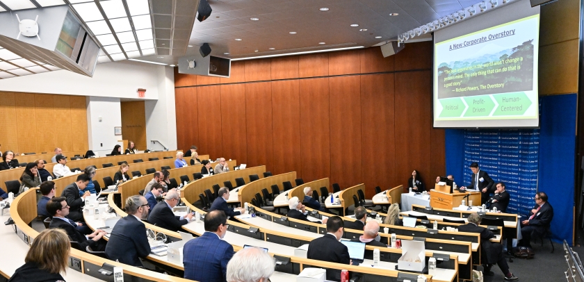 Audience in classroom listening to panel speakers