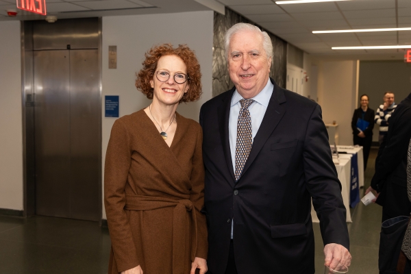 Woman in brown dress with man in tie and jacket